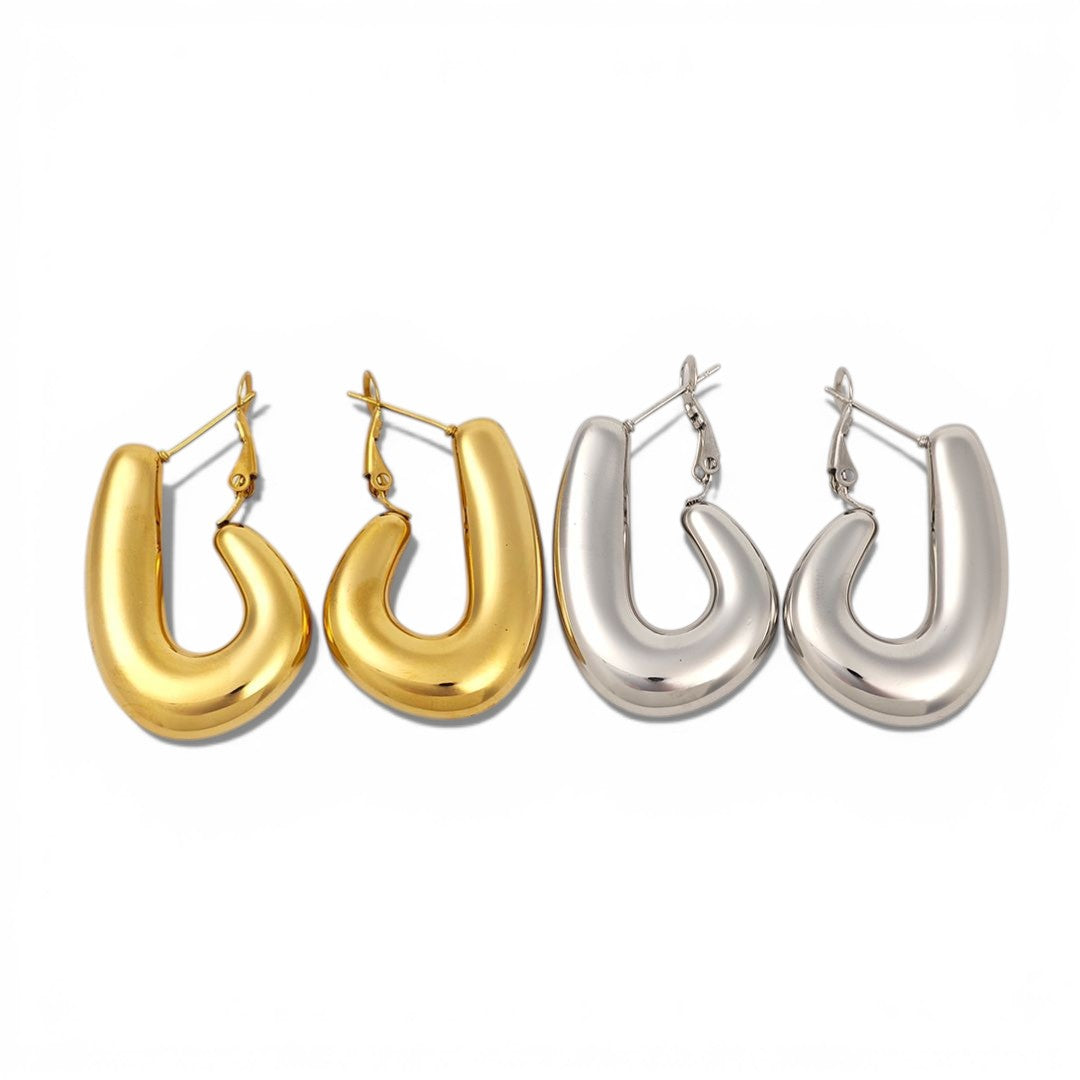 Pair of gold hoop earrings and pair of silver hoop earrings on a white background