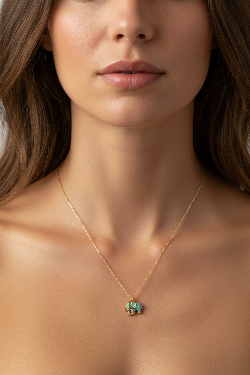 Close-up of a woman wearing a gold necklace with a elephant pendant.