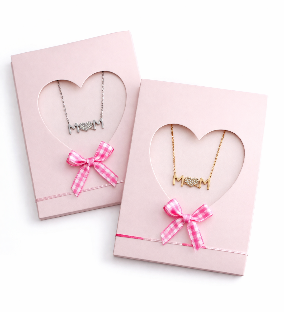 Two Mom necklaces in pink heart-shaped boxes with bows on a white background