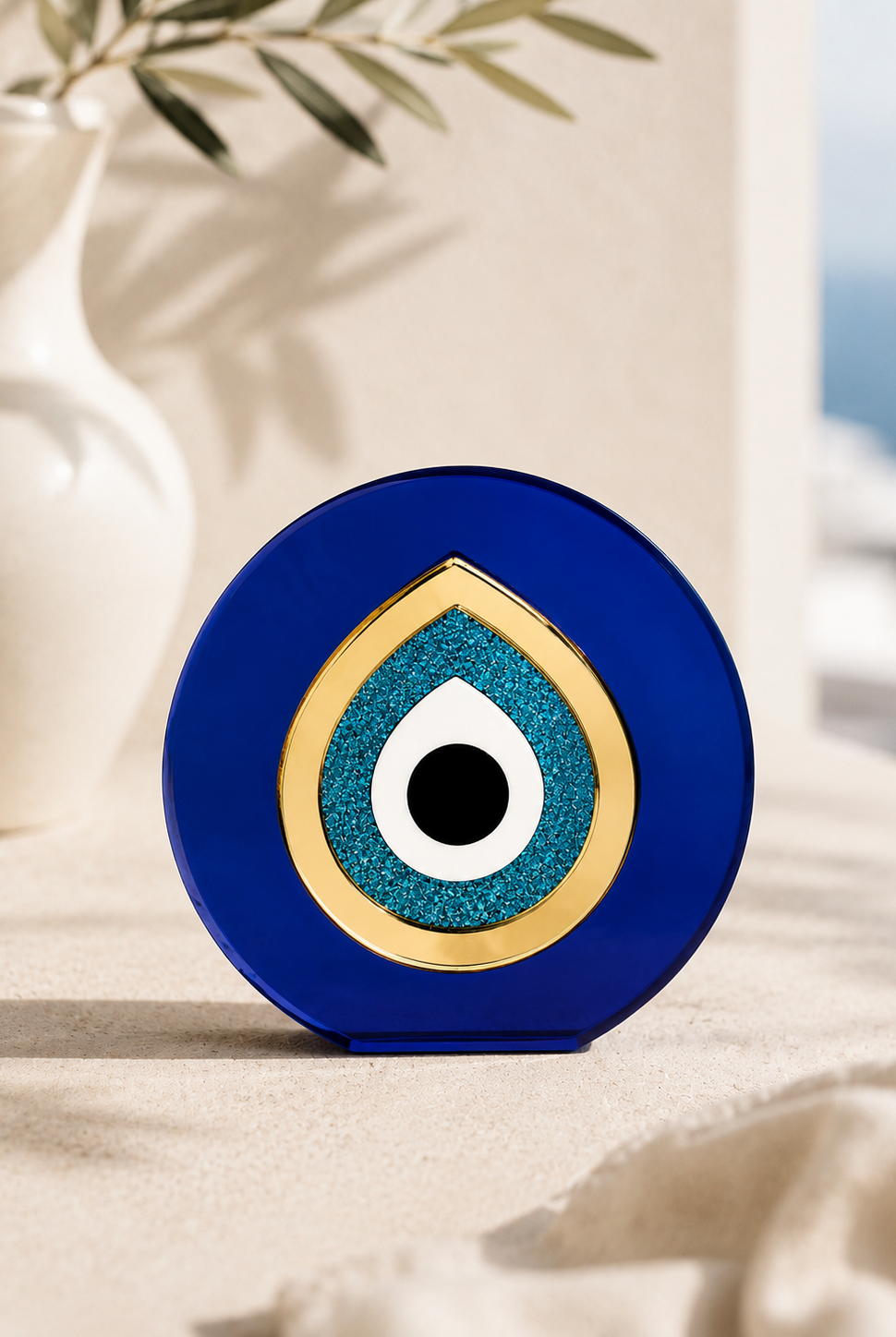 Paros Eye minimal Mediterranean evil eye tabletop decor in cobalt blue and gold mirror acrylic styled in a Cycladic luxury setting