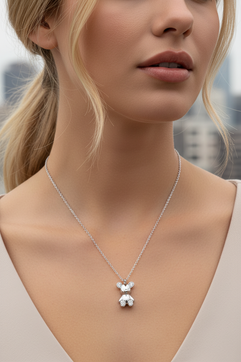Close-up of a woman wearing a silver necklace with a bear pendant against an urban background. So cute by dimi