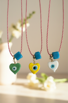 Χειροποίητο κολιέ Μάρτης Aegean Heart με lampwork καρδιά με μάτι και γυάλινο τυρκουάζ κύβο – So Cute by Dimi