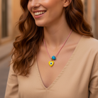 Χειροποίητο κολιέ Μάρτης Aegean Heart με lampwork καρδιά με μάτι και γυάλινο τυρκουάζ κύβο – So Cute by Dimi