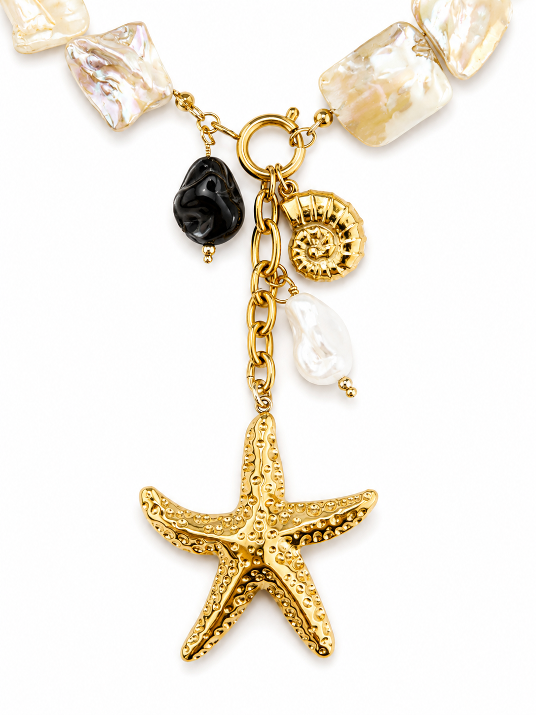 Gold stainless steel necklace with natural freshwater pearls, front clasp and sea-inspired charms including starfish, shell and ammonite.