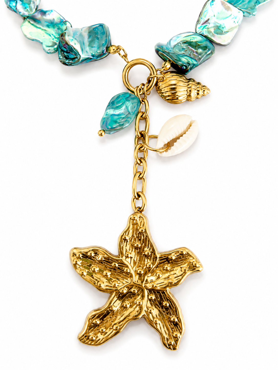 So Cute by Dimi Nausicaa Necklace featuring turquoise mother of pearl beads, a gold flower charm, shell charm and stainless steel front clasp.