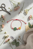 Bracelet with floral design on a textured surface with flowers and scissors