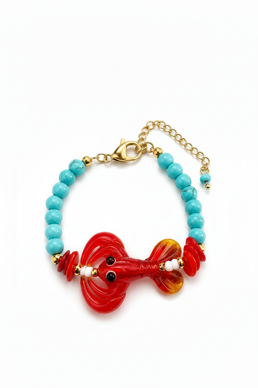 A handmade glass bead bracelet featuring a red lobster charm, turquoise blue beads, gold-tone chain extender, and a white brand tag that reads 'Socute Handmade Jewelry'.