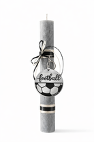 Decorative easter candle with a 'football' charm on a white background