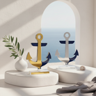 Decorative anchors on a white surface with a window view of blue water and sky.