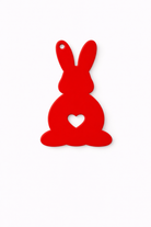 Red bunny-shaped ornament with a heart on a white background