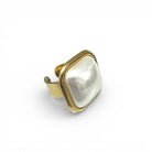 Gold ring with a large white gemstone on a white background