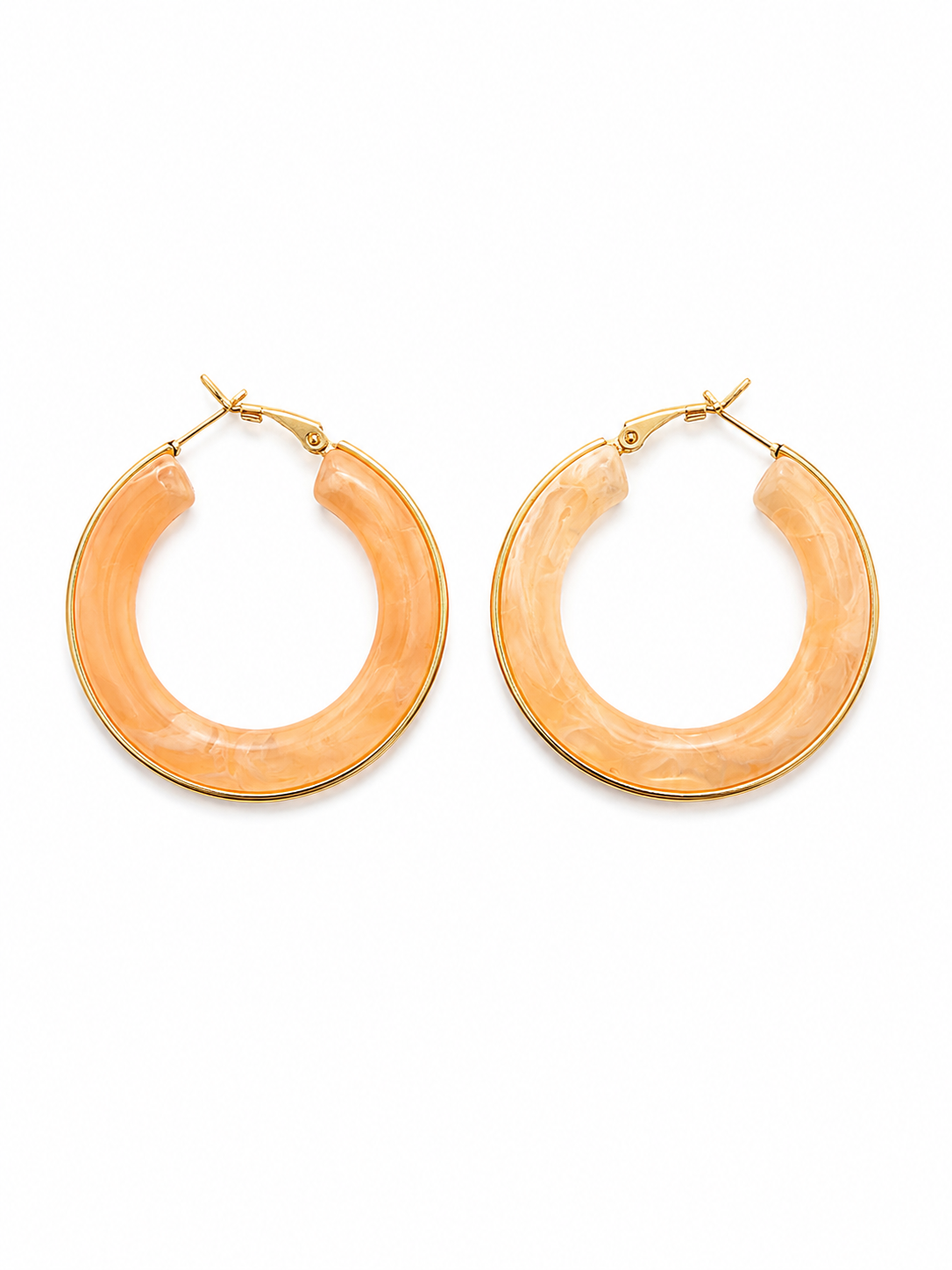Pair of peach-colored hoop earrings on a white background