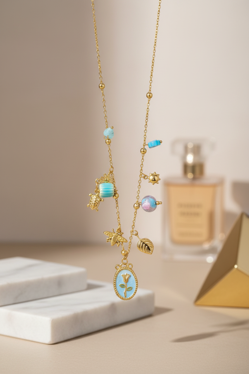 Delicate gold necklace with blue and pink gemstones on a neutral background