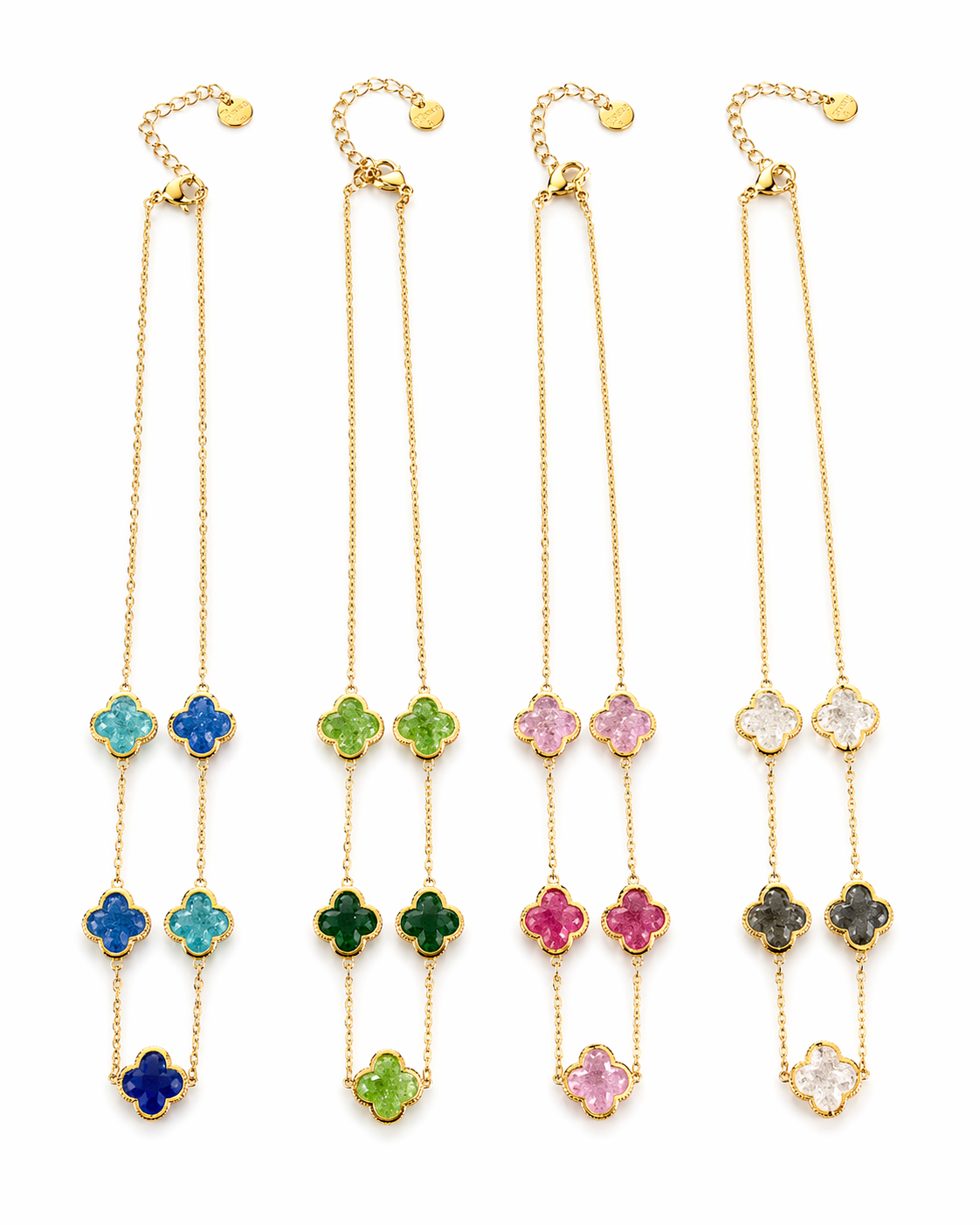 Set of four gold necklaces with colorful flower pendants on a white background