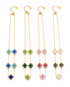 Set of four gold necklaces with colorful flower pendants on a white background
