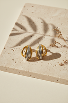 Contour Sculptural Earrings σε δίχρωμο χρυσό και ασημί φινίρισμα σε minimal flatlay