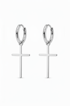 Silver hoop earrings with cross pendants on a white background