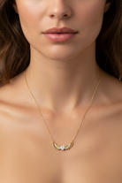 Close-up of a necklace with a pendant on a model's neck