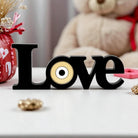 Επιτραπέζιο διακοσμητικό LOVE από plexiglass με χρυσό μάτι και μαύρη βάση