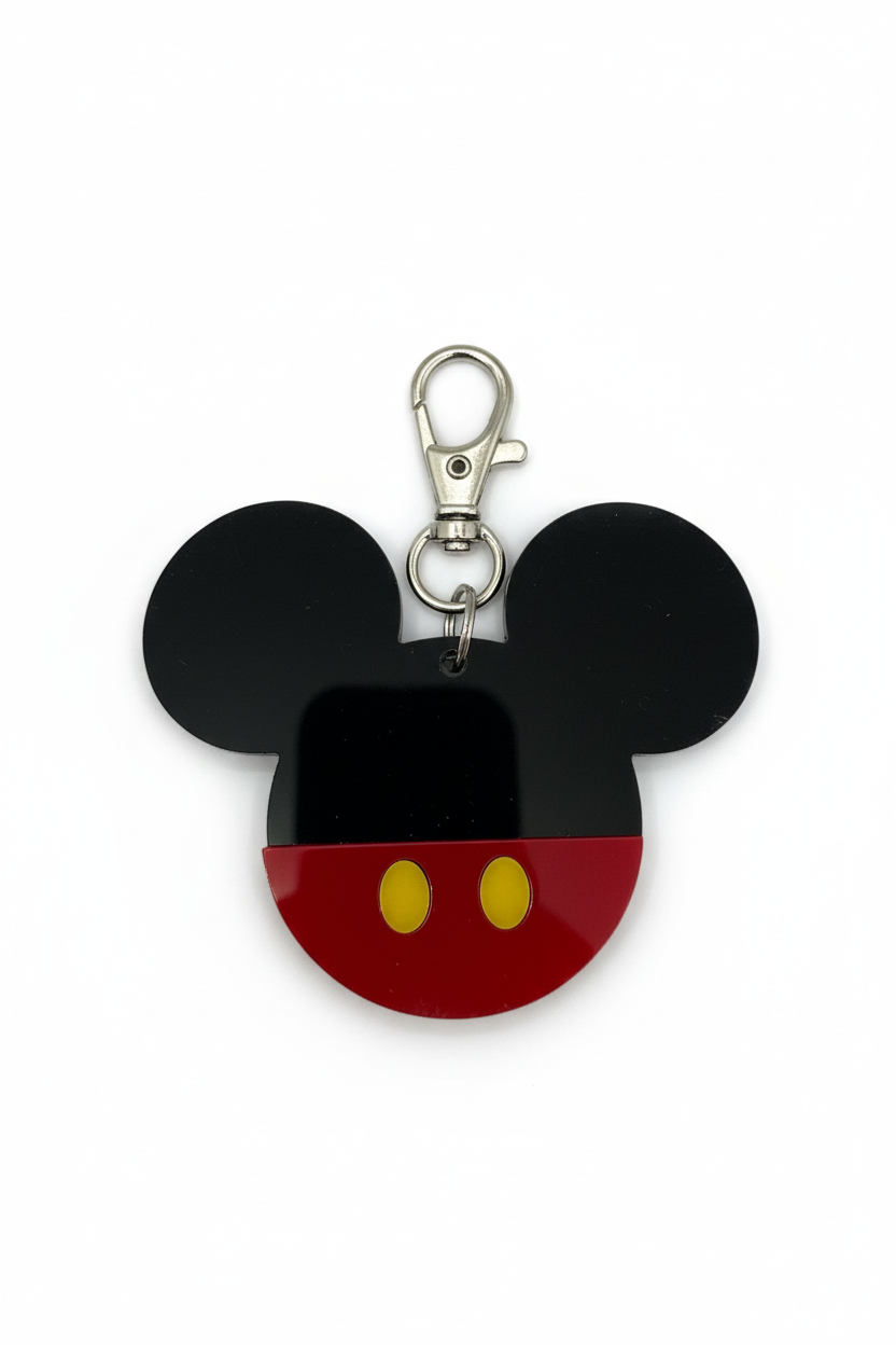 Mickey Mouse head keychain with black ears, red face, and yellow buttons on a white background