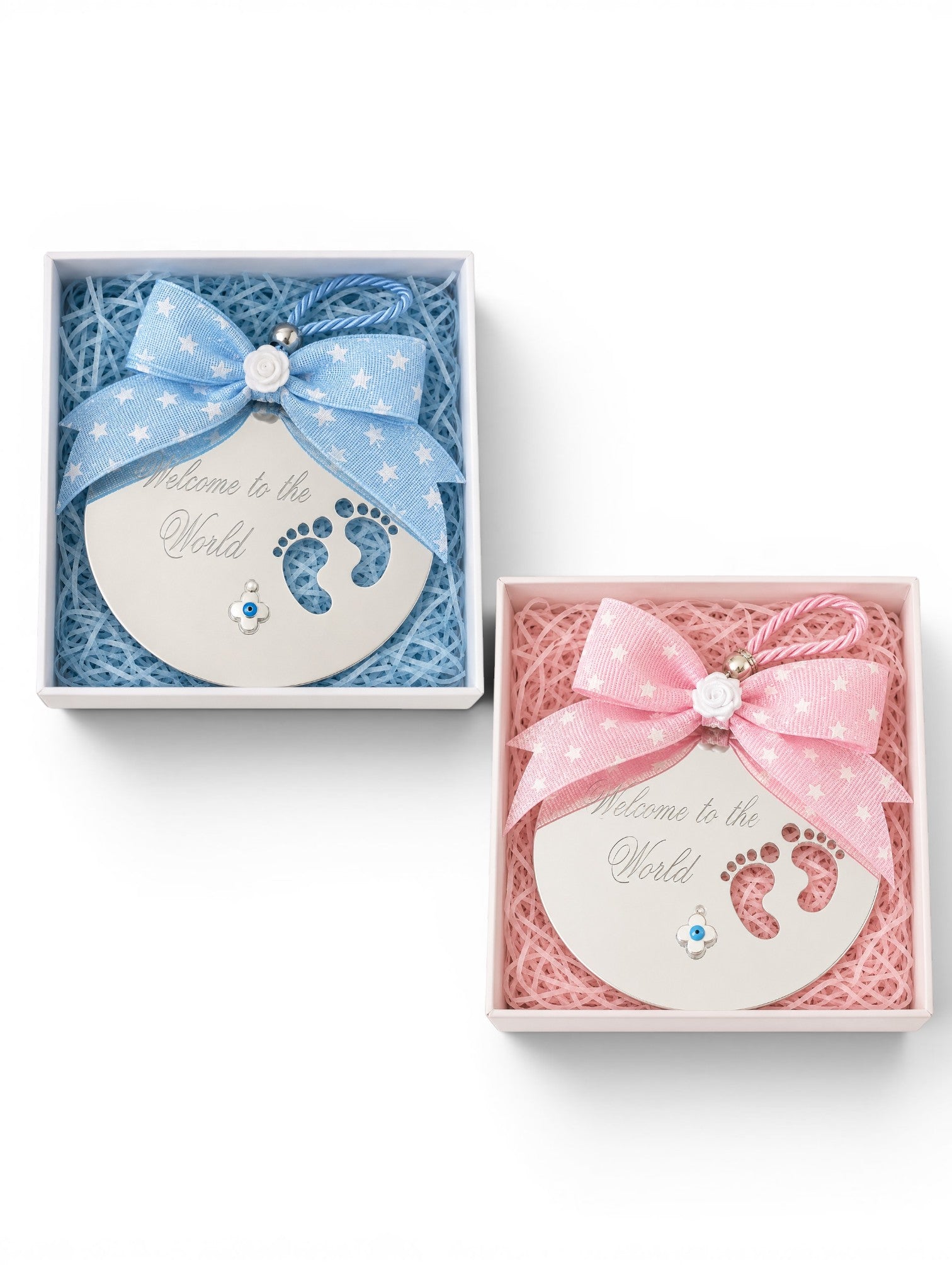 Two baby keepsake gift boxes on a white background, one blue and one pink, each containing a round disc from acrylic mirror with baby footprints and a matching ribbon bow.