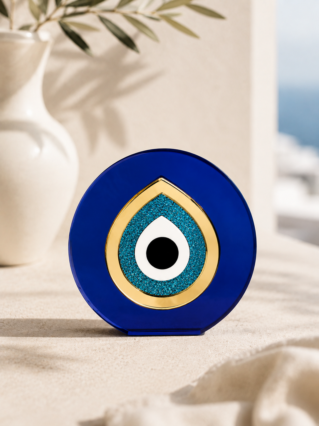 Paros Eye minimal Mediterranean evil eye tabletop decor in cobalt blue and gold mirror acrylic styled in a Cycladic luxury setting
