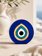 Paros Eye minimal Mediterranean evil eye tabletop decor in cobalt blue and gold mirror acrylic styled in a Cycladic luxury setting