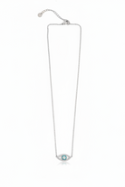 Silver necklace with a blue evil eye pendant on a white background