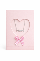 Necklace with 'MOM' pendant and pink bow in a heart-shaped pink box on a white background