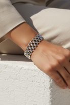 Silver stainless steel pyramid link bracelet worn on wrist, geometric stud bracelet modern jewelry