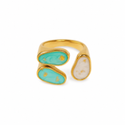Gold ring with turquoise and beige stones on a white background