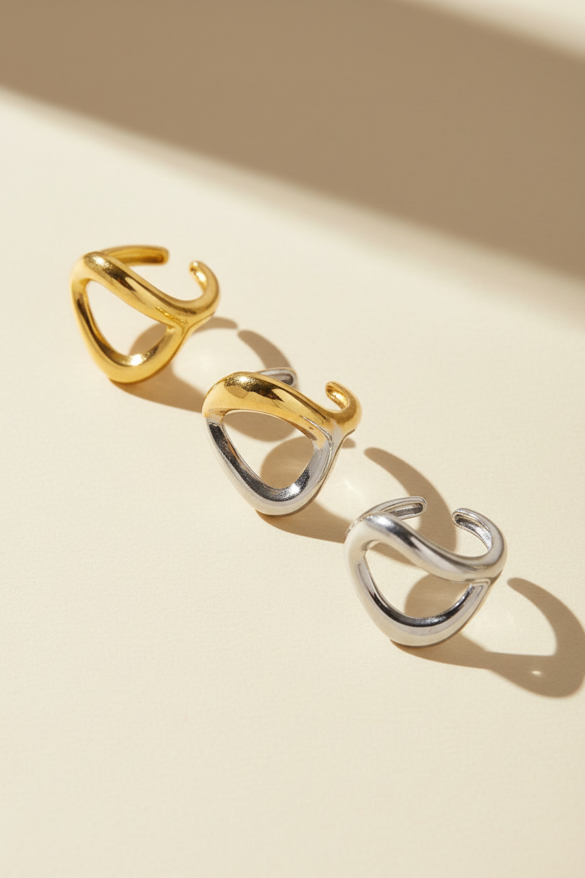 Three gold, two-tone and silver stainless steel rings on a white background, So Cute by Dimi