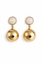 Pair of gold earrings with white stones on a white background