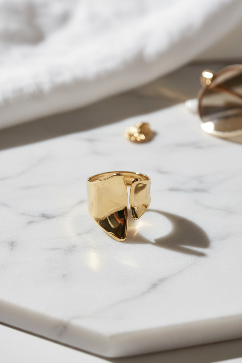 Zirelle open ring σε χρυσό πάνω σε marble επιφάνεια σε minimal καλοκαιρινό flatlay